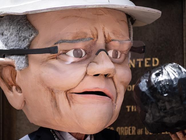 A protester dressed as Scott Morrison holding a piece of coal on March 15, 2019 in Hyde Park, Sydney, Australia. Picture: Getty