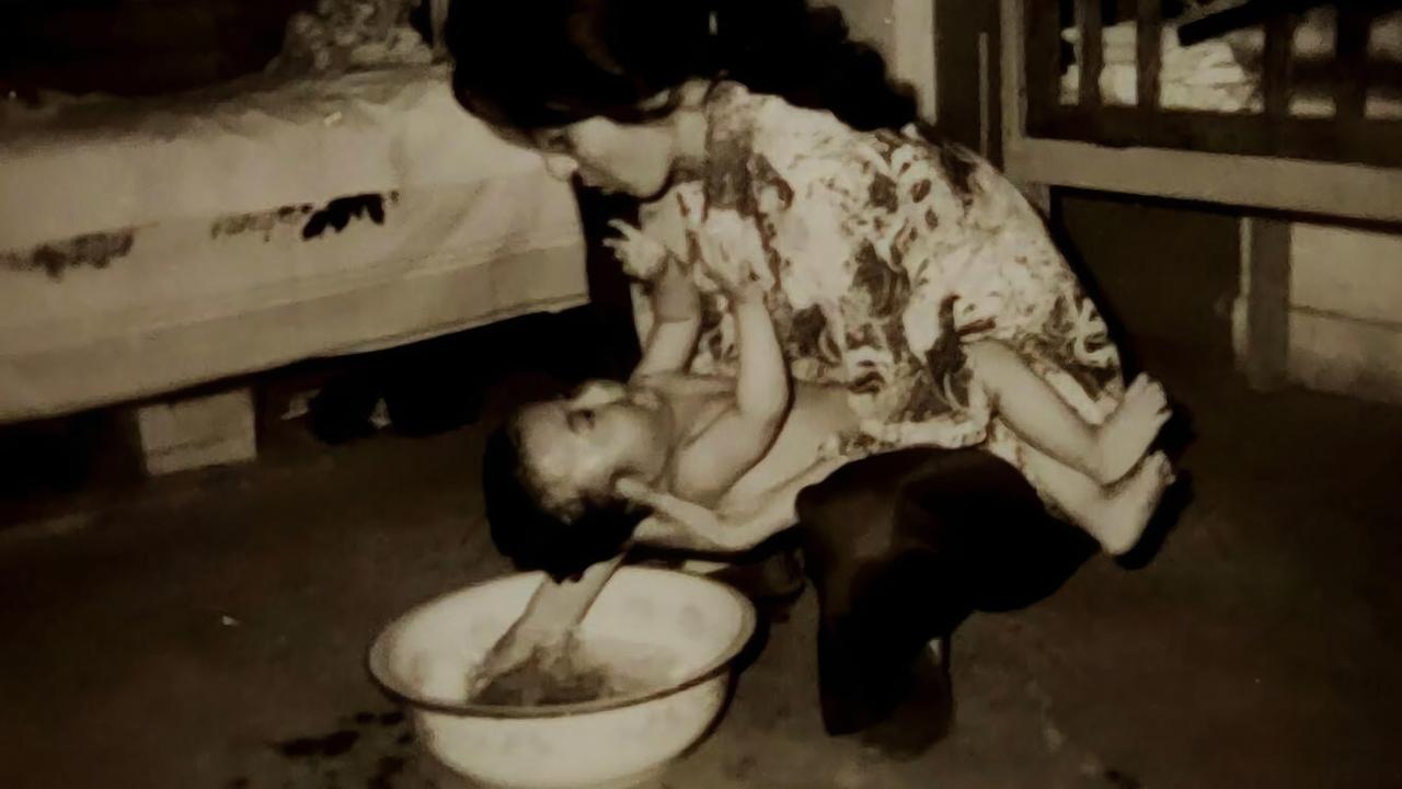 Bruce's mum giving him a bath in China. Picture: Supplied