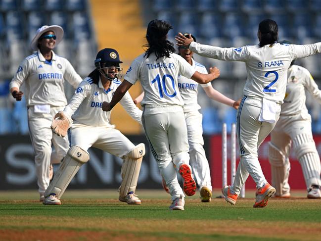 India's players celebrate after the dismissal of Australia's Alana King during the final day of the women's Test cricket match between India and Australia at the Wankhede Stadium in Mumbai on December 24, 2023. (Photo by Indranil MUKHERJEE / AFP) / -- IMAGE RESTRICTED TO EDITORIAL USE - STRICTLY NO COMMERCIAL USE --