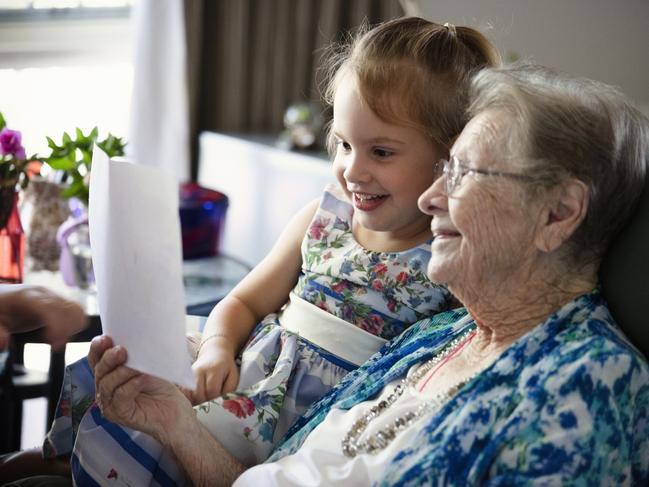 Prime Minister Scott Morrison has announced a Royal Commission into the Aged Care sector, Pictured is St Paul’s Aged Care resident Olive Reynolds reading to 4-year-old Melody Webber