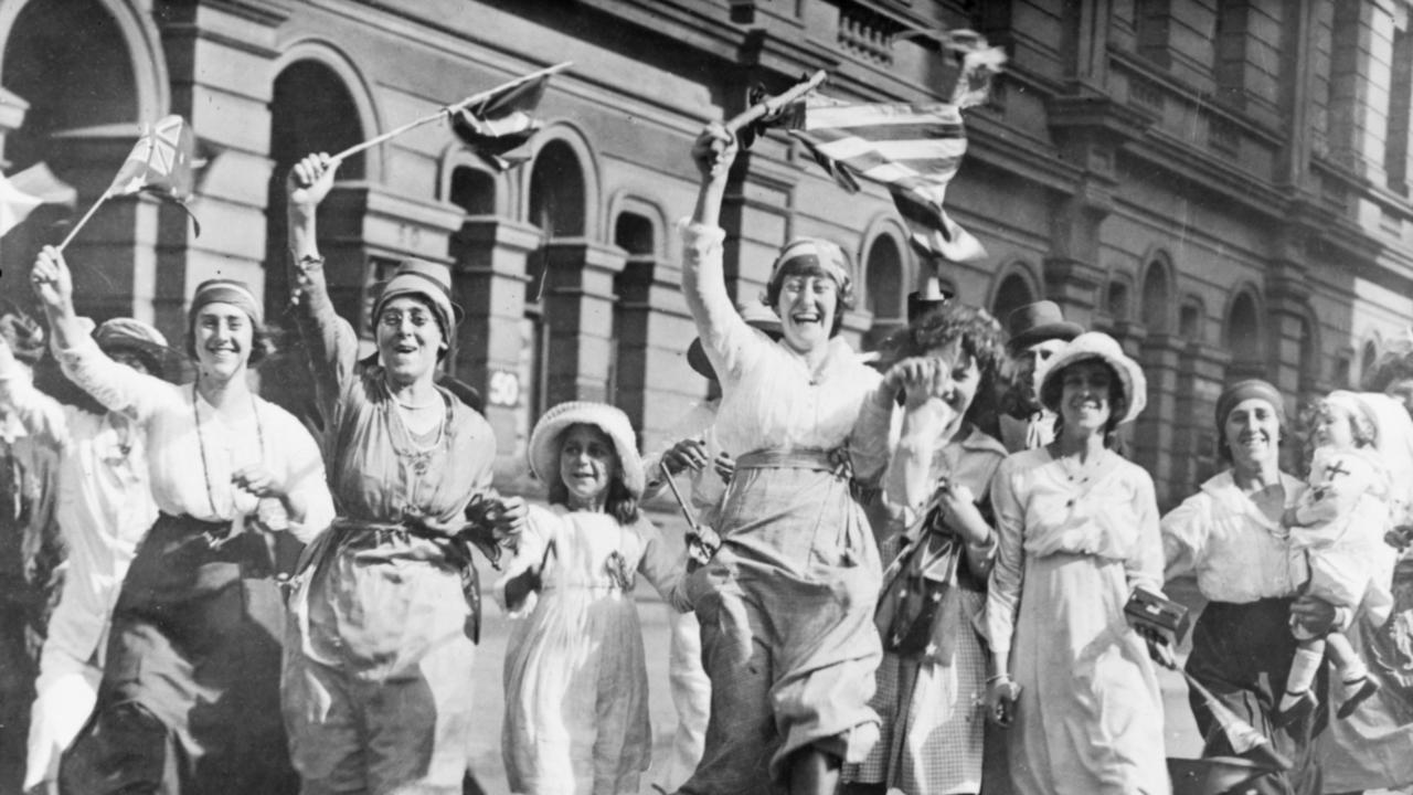 A group of women and children rejoicing in the street in Australia at the signing of the Armistice on November 11, 1918. Picture: Australian War Memorial Remembrance Day