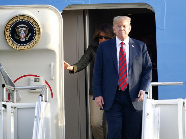 U.S. President Donald Trump and first lady Melania Trump disembark from Air Force One as they arrive at Prestwick Airport, in Ayrshire, Scotland, Friday, July 13, 2018. (AP Photo/Peter Morrison)