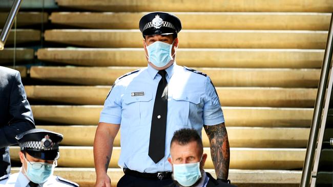 Constable Zachary Schembri &amp; Constable Shane Warren (pictured) leave the Townsville Courthouse after giving evidence at an inquest. Pictured with Queensland Police Union representative. Picture: Alix Sweeney