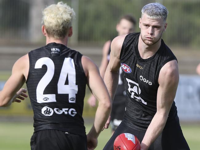 Port Adelaide’s Kane Farrell and Peter Ladhams at Alberton Oval. Picture: Sarah Reed