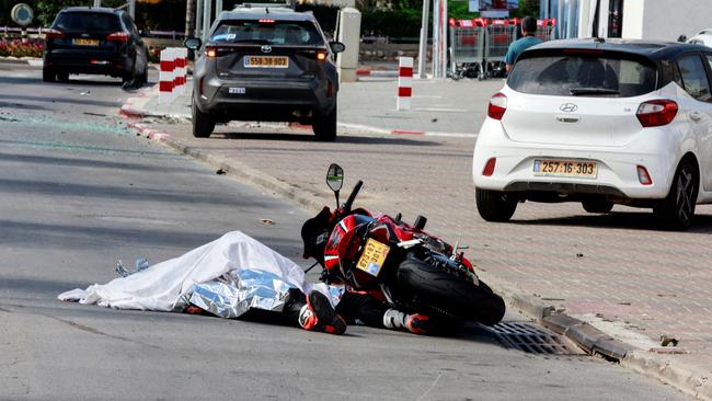 The body of a motorist lies on a road following a mass-infiltration by Hamas gunmen Picture.: REUTERS/Ammar Awad