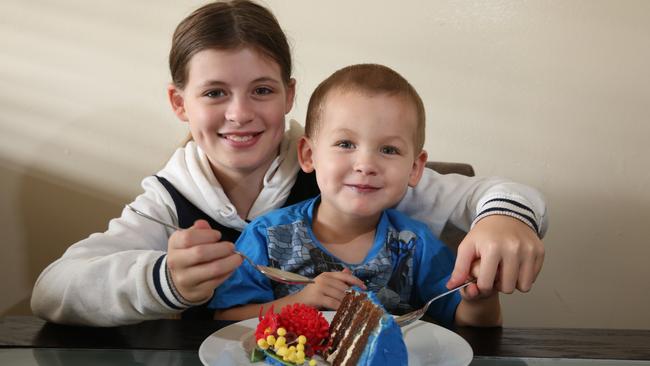 Children Taliyah, 12, and Blaine, 3, enjoy a slice of their mum’s cake.