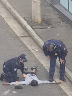 Police searching the young male in Surry Hills.