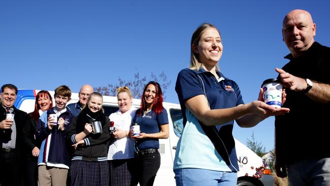 Daily Grind volunteers at Kellyville with Emily Skinner handing over a cup of coffee to Graham Chene. Picture: Peter Kelly