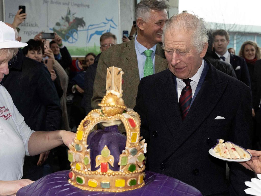 King Charles III getting a taste of his forthcoming coronation with a slice of the crown cake on his recent visit to Germany. Picture: Stephen Lock/pool/AFP