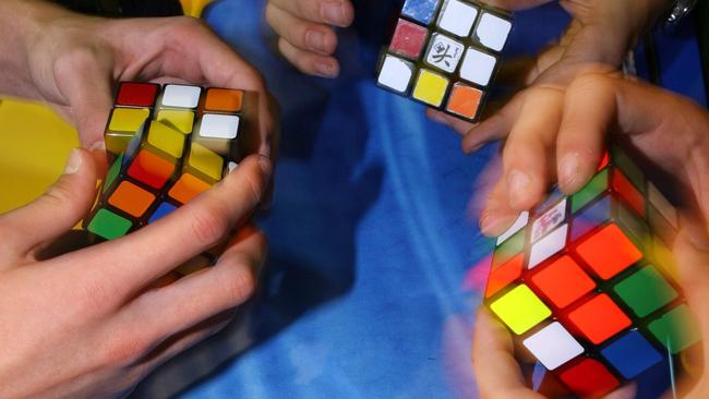 People try to solve the Rubik’s cube on the final day of the 2010 Rubik’s cube German Championships.