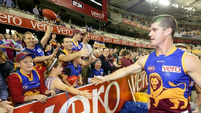 Jonathan Brown celebrates a Lions victory with fans at the Gabba.