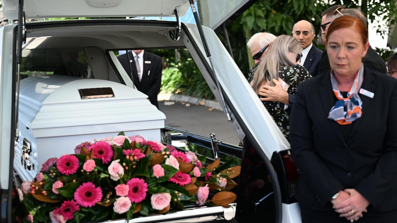 Victor White, the husband of slain grandmother Vyleen White, is hugged by a mourner after her memorial service. Picture: Dan Peled / NCA Newswire