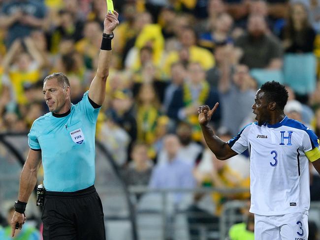 Maynor Figueroa of Honduras receives a yellow card