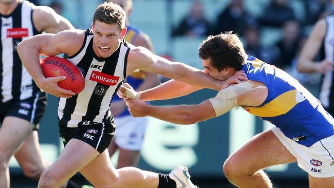 AFL Round 17. 15/07/2018. Collingwood v West Coast at the MCG.  Collingwood's Taylor Adams pushes away the tackle of West Coast's Andrew Gaff 2nd qtr    . Pic: Michael Klein