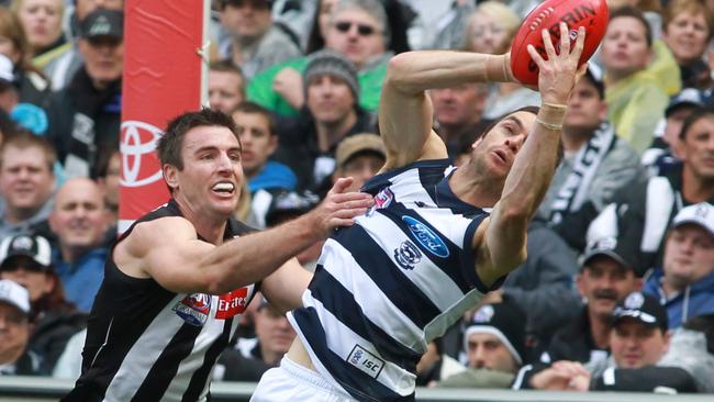 Matthew Scarlett marks in front of Darren Jolly in the 2011 Grand Final.