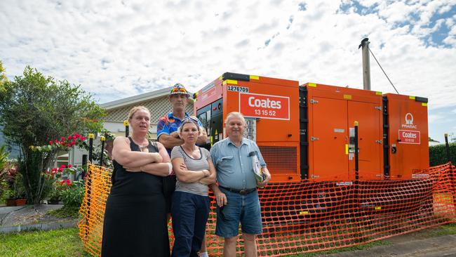 Kerri Mason, Kerrie Dowd, Pat Wilcocks and George Pawlowski with one of the eight generators that have been supplying power to the flood damaged community. Picture Emily Barker.