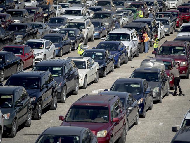 Vehicles line up to receive free food in Austin, Texas. The Central Texas Food Bank distributed free emergency food boxes to help those who are facing increased food insecurity during the COVID-19 pandemic. Picture: Nick Wagner/Austin American-Statesman via AP