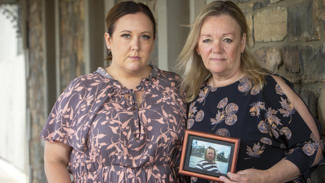 Joanne Toft (right) holding an image of her husband Stephen Toft, with Strathalbyn Commercial Hotel publican Stacey Butler. Picture: Emma Brasier