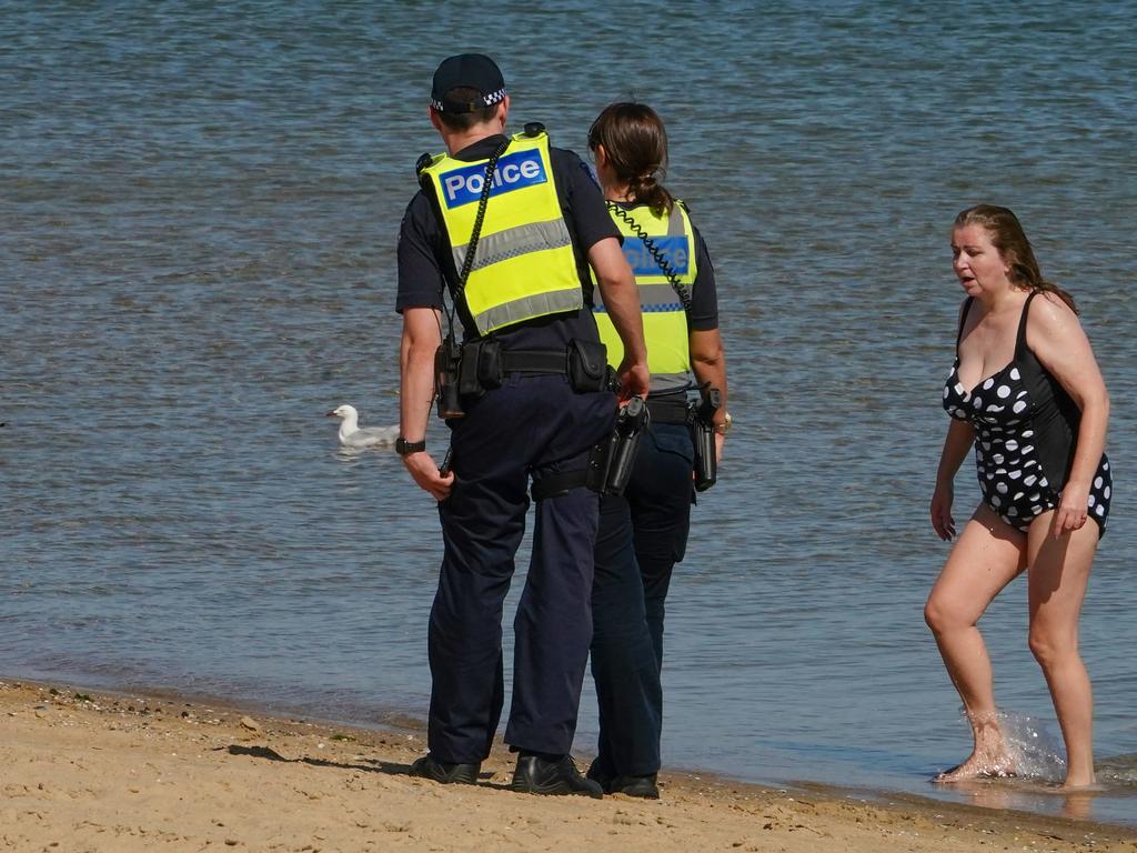 Police tell beachgoers to leave St Kilda beach after crowds flouting social distancing rules forced authorities to close it. Picture: Scott Barbour