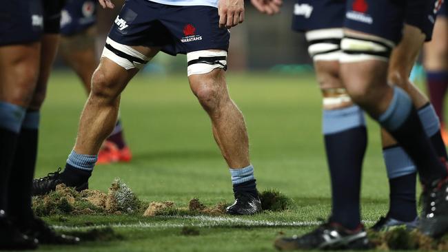 SYDNEY, AUSTRALIA - MARCH 09: Players replace divots after a scrum during the round four Super Rugby match between the NSW Waratahs and the Queensland Reds at the Sydney Cricket Ground on March 09, 2019 in Sydney, Australia. (Photo by Ryan Pierse/Getty Images)