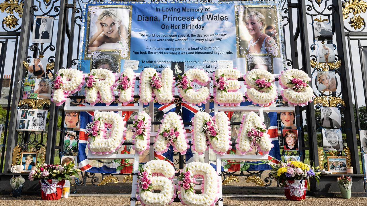 Flags, balloons and messages are seen as Royal fans pay their respects on what would have been the 60th birthday of Princess Diana. Picture: Getty Images.