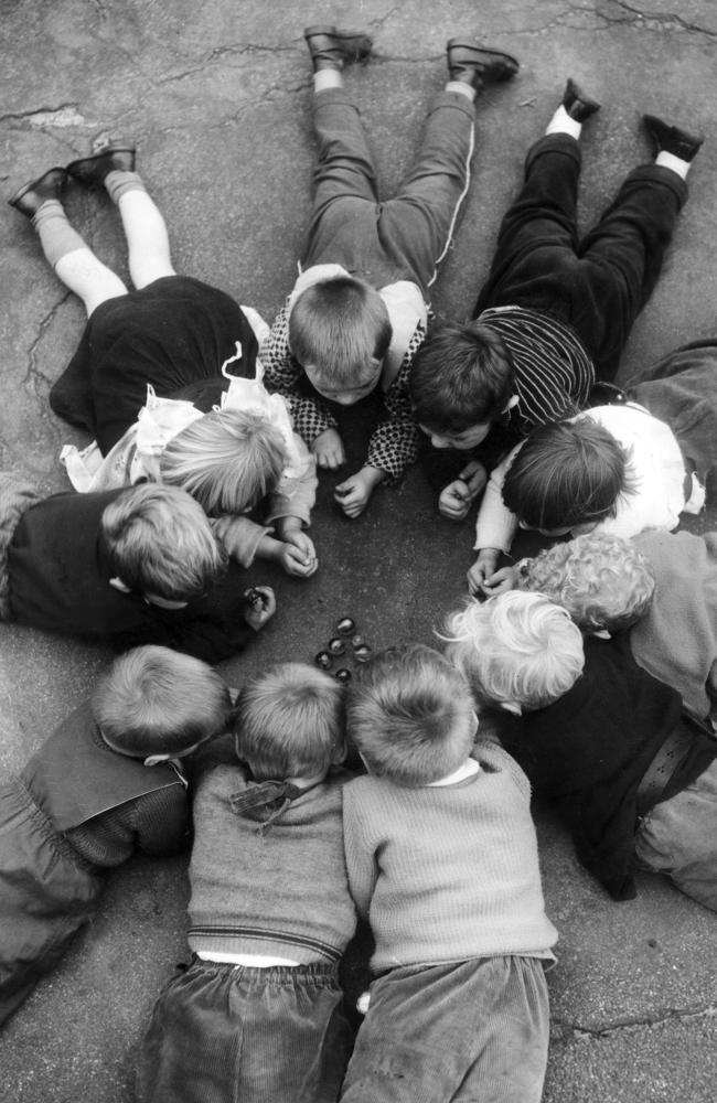 Kids play marbles in 1962.