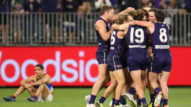 PERTH, AUSTRALIA - MAY 26: Michael Walters of the Dockers is congratulated by team mates after kicking a point to win the game during the round 10 AFL match between the Fremantle Dockers and the Brisbane Lions at Optus Stadium on May 26, 2019 in Perth, Australia. (Photo by Paul Kane/Getty Images)