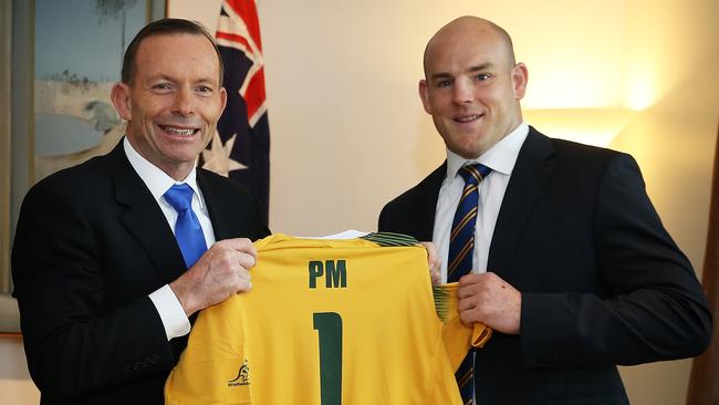 Then PM Tony Abbott gets a jersey from Wallabies captain Stephen Moore. Picture: Kym Smith