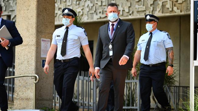 Constable Zachary Schembri (front) &amp; Constable Shane Warren leave the Townsville Courthouse after giving evidence at an inquest. Pictured with Queensland Police Union representative. Picture: Alix Sweeney