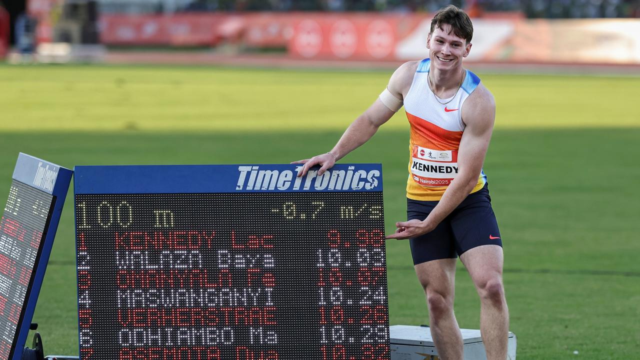 Australia's Lachlan Kennedy poses next to his time. He’s just the second Aussie to run the 100m in less than 10 seconds. (Photo by Tony KARUMBA / AFP)