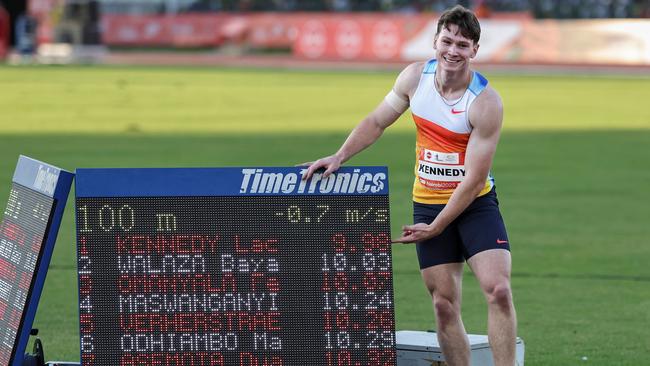 Australia's Lachlan Kennedy poses next to his time. He’s just the second Aussie to run the 100m in less than 10 seconds. (Photo by Tony KARUMBA / AFP)