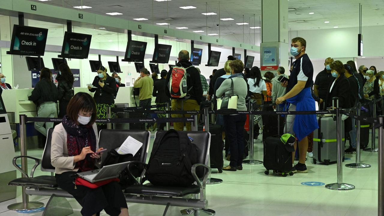 Travellers queue up in front of the check-in counters. Picture: AFP