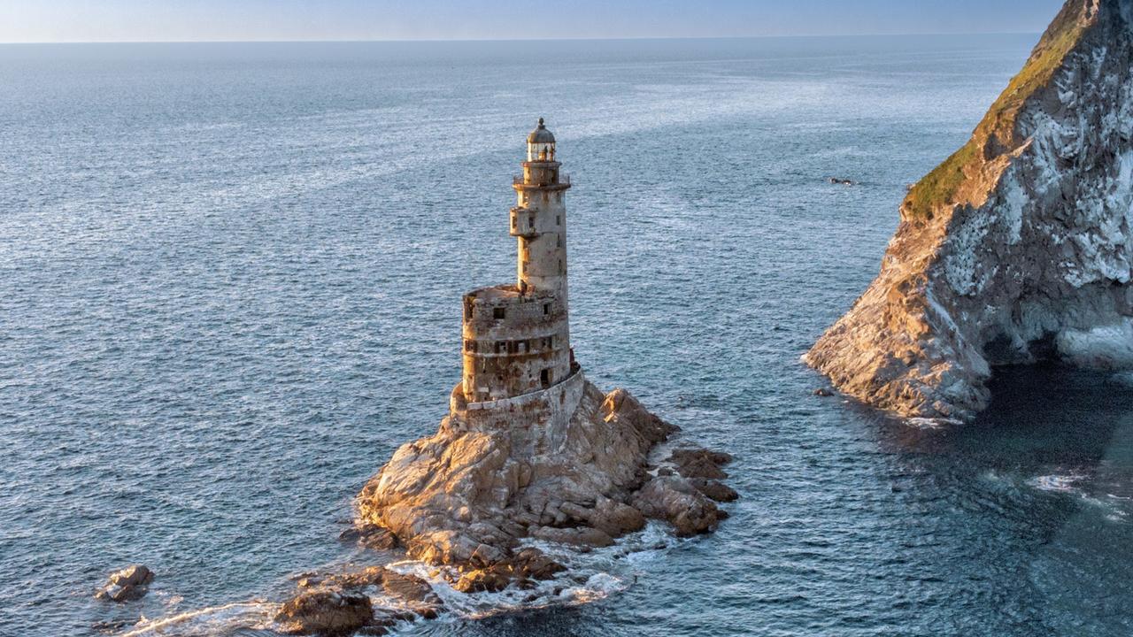 A creepy lighthouse left to rot sits ominously on a remote Island, yet hundreds of tourists make the treacherous trip there each year. Picture: istock