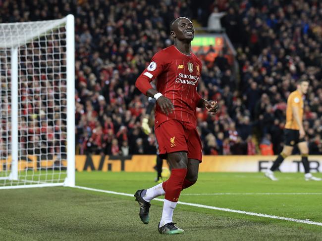 Liverpool's Sadio Mane smiles after scoring the opening goal during the English Premier League soccer match between Liverpool and Wolverhampton Wanderers at Anfield Stadium, Liverpool, England, Sunday Dec. 29, 2019. (AP Photo/Jon Super)