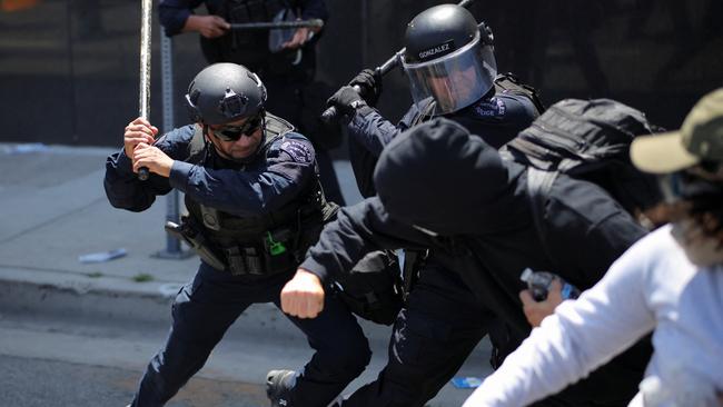Members of the Los Angeles Metro Police clash with demonstrators during a protest against federal immigration sweeps. Picture: Reuters.