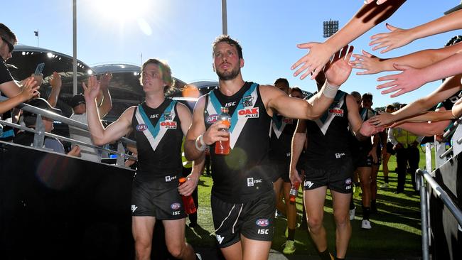 Jared Polec and Travis Boak of the Power walk down to the change rooms after the win against Brisbane. Picture: AAP Image/David Mariuz