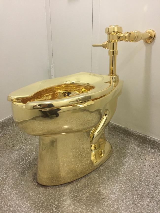 A fully functioning solid gold toilet, made by Italian artist Maurizio Cattelan, which was going into public use at the Guggenheim Museum in New York. Picture: AFP Photo/ William Edwards