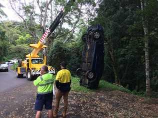 A crane was used to retrieve a car from down a 30-foot embankment off Tuntable Creek Road.. Picture: Marc Stapelberg