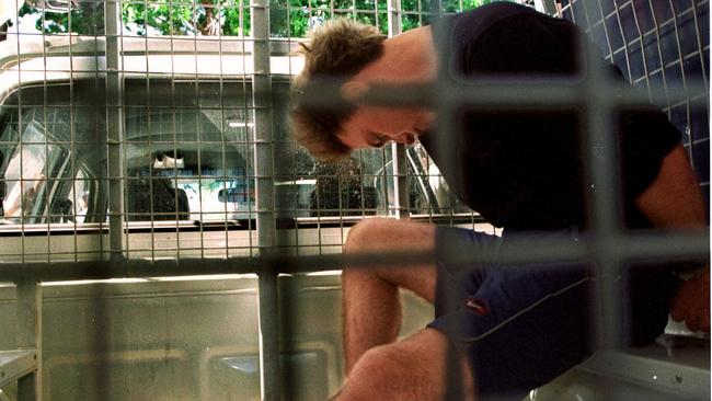 Fugitive Brendan Berichon accomplice of criminal Brenden Abbott sitting in back of police van after his capture in Darwin. 