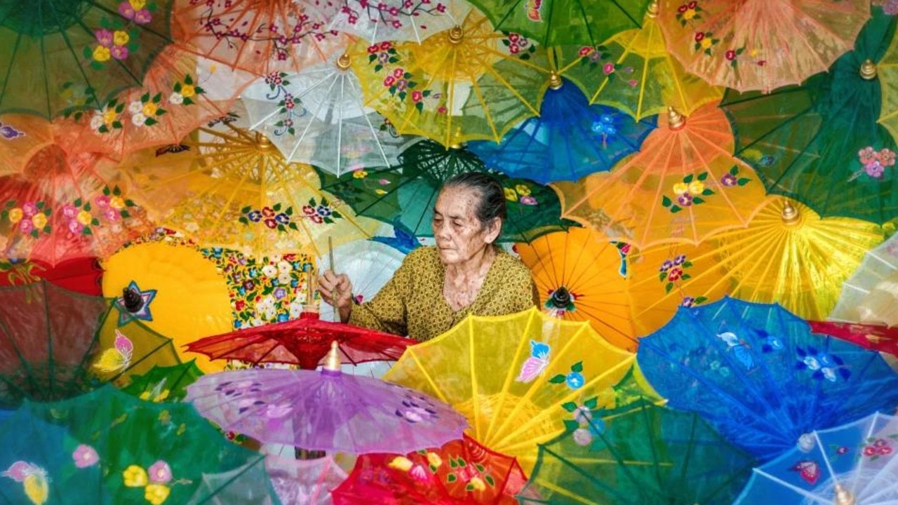 A craftswoman of colourful umbrellas in Indonesia. Picture: Dedy Dhamiyanto/Agora Images