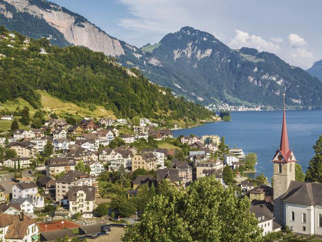 DECEMBER 6 2015 DEALS Lake Lucerne in Switzerland. For use with Insight Vacations copy. Picture: Supplied Beautiful mountain scenery with the town of Weggis at the northern shore of Lake Lucerne in beautiful evening light at sunset, Canton of Lucerne, central Switzerland