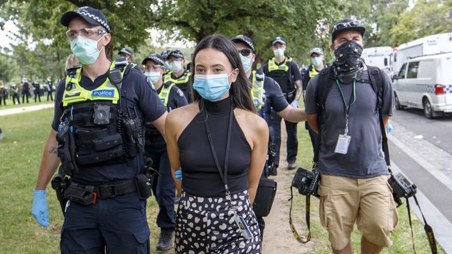 Herald Sun Reporter Olivia Jenkins and photographer Jake Nowakowski being arrested at an anti-vaccination protest at Fawkner Park. Picture: NCA NewsWire