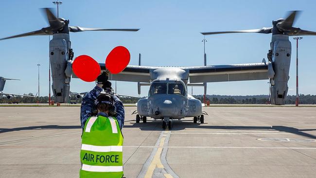 An Air Movements member from No. 23 Squadron marshals a United States Marine Corps MV-22B Osprey aircraft, upon arrival to RAAF Base Amberley, outside of Ipswich, on July 20, during Exercise Talisman Sabre 2021. Picture: Sergeant Peter Borys