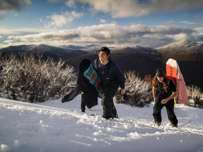 Rentaro Thomas, 20, (l) from Sydney, and Thomas Frieberg, 24, from Brisbane walk past Five Ways on their way to the top of Walkabout run at Thredbo, NSW, ahead of the 2020 snow season, which opens Monday 22 June. Picture by Sean Davey.