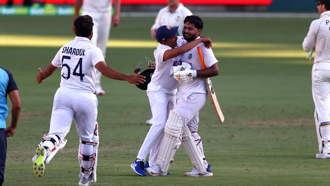 India's batsman Rishabh Pant (C) is embraced by teammates after achieving the incredible. Picture: AFP