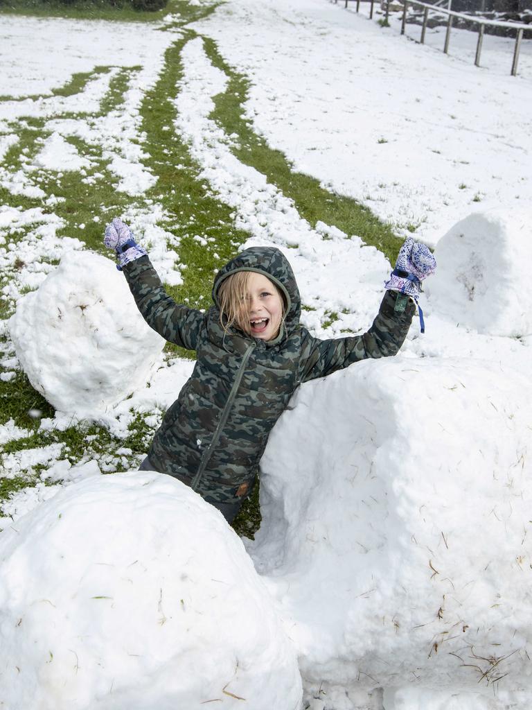 Lizzy (8) celebrating the latest Spring snow at home at Ferntree. Picture Eddie Safarik