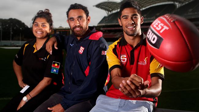 Former Crow Richard Tambling, centre, with members of his SANFL Traineeship program - Kayannah Kartinyeri, 19, and Jharien Owen, 18. Picture: Sarah Reed.