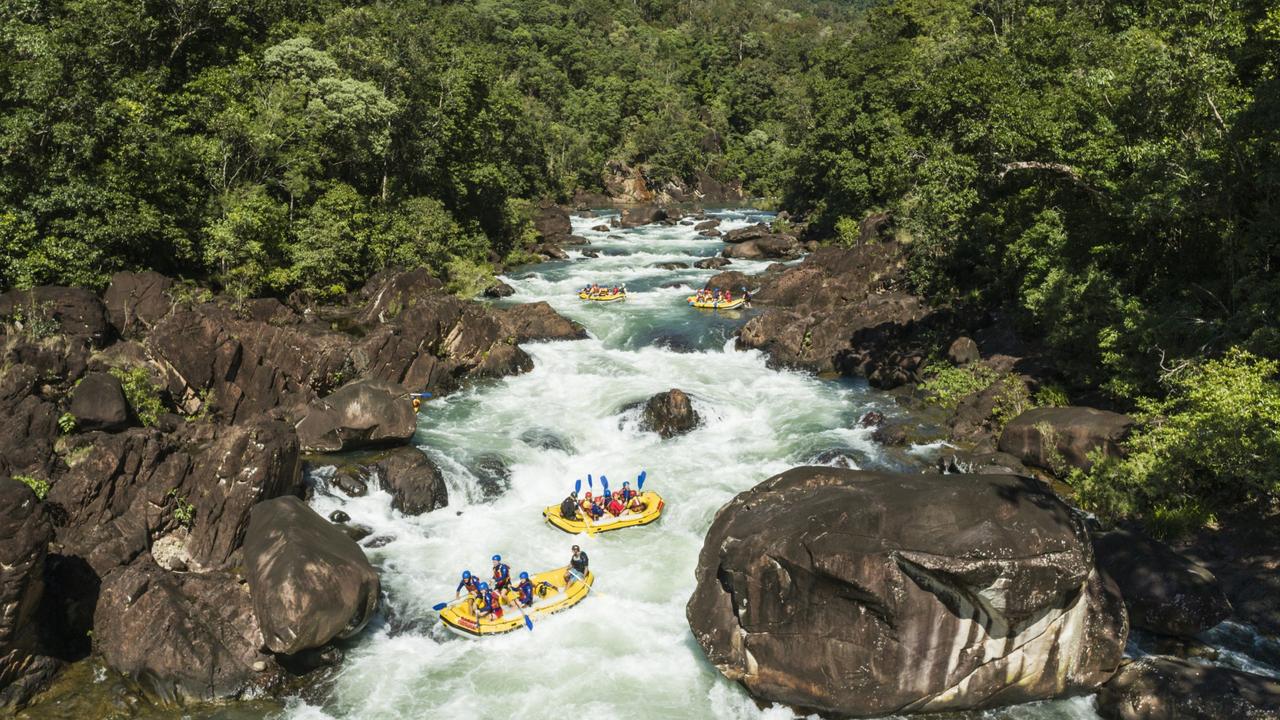 Aerial view of white water rafts in the rainforest surrounds of the Tully Gorge. Photo: TTNQ