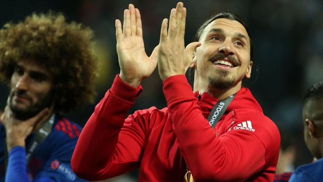 Manchester United's injured Swedish striker Zlatan Ibrahimovic (R) celebrates after his team won the UEFA Europa League final football match Ajax Amsterdam v Manchester United on May 24, 2017 at the Friends Arena in Solna outside Stockholm. / AFP PHOTO / Soren Andersson