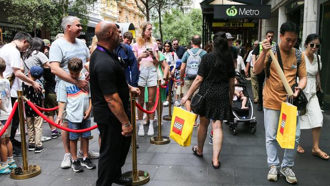 Cost of living pressures didn’t stop families lining up for Sydney’s new Lego store, although the latest RBA rate hike was another blow to consumer confidence. Picture: Gaye Gerard